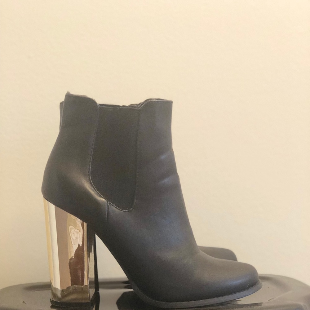 Black boots with gold heels